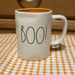 Rae Dunn mug with black “boo!” Text and orange inside